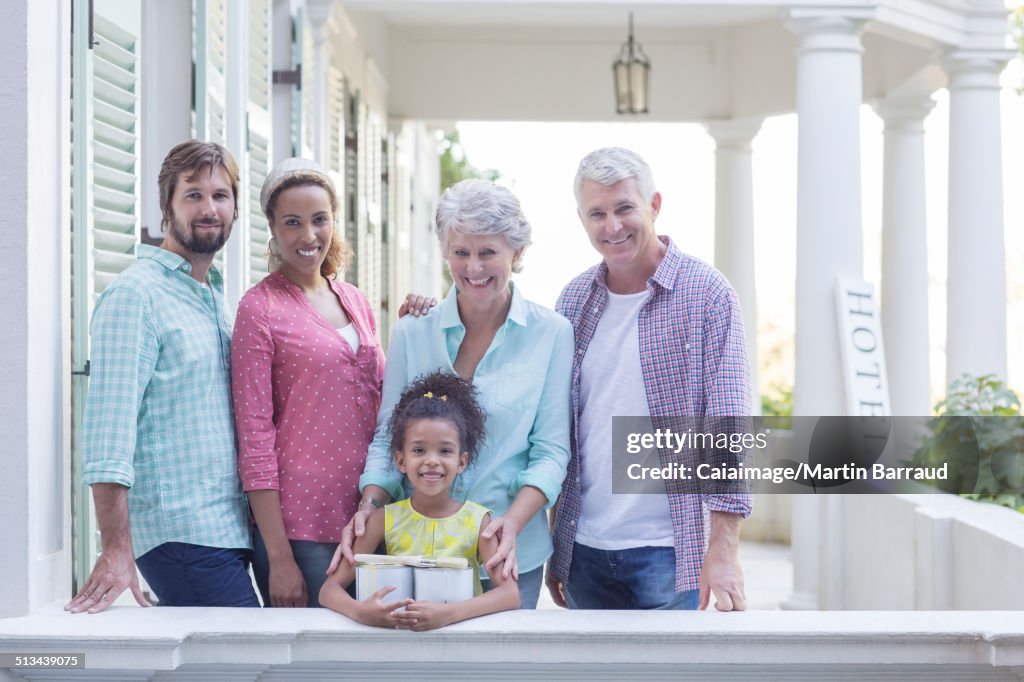 Family smiling on porch together