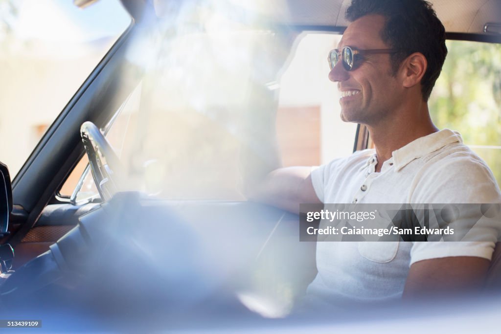 Man driving car on sunny day