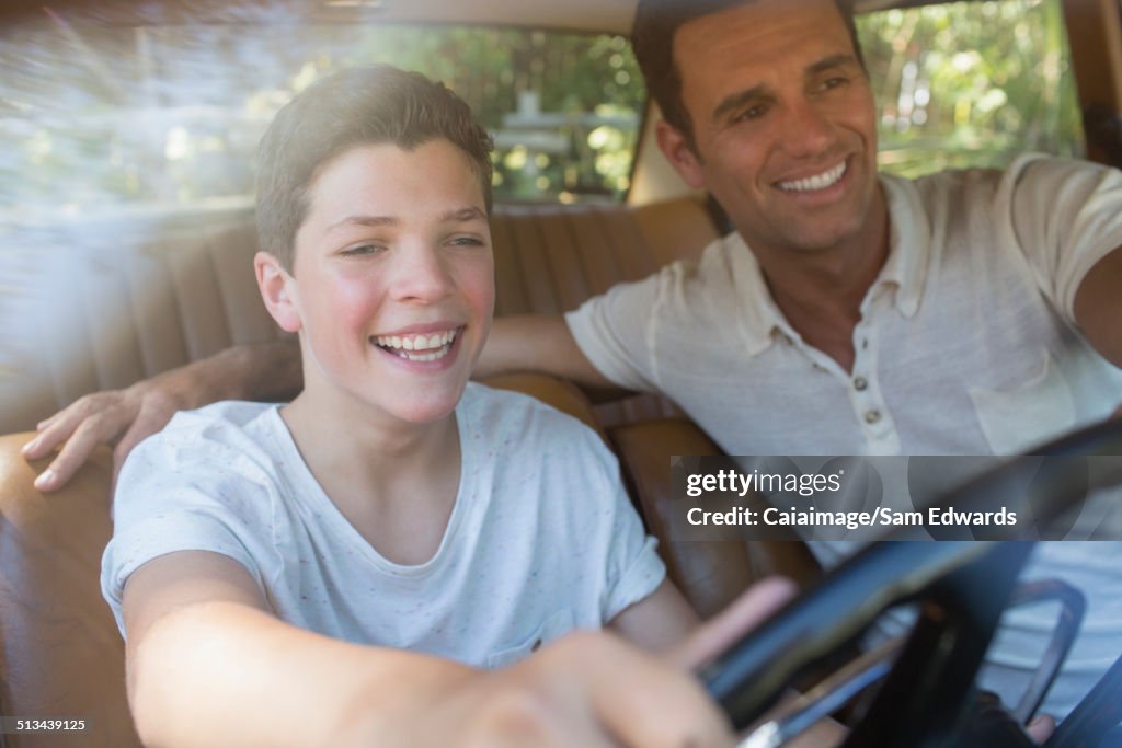Father teaching son to drive