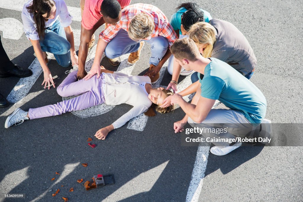 People rushing to injured girl on street