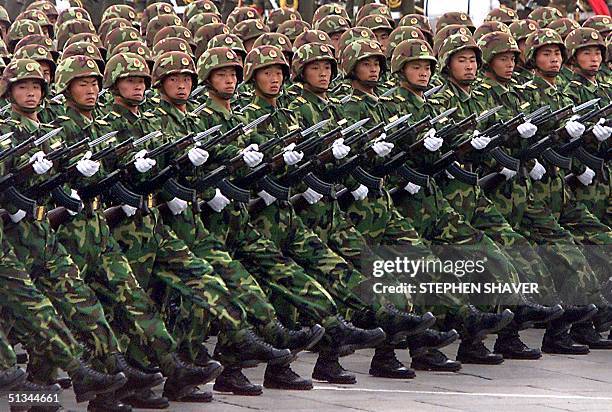 October 1999 file photo shows Chinese People's Liberation Army soldiers marching with their bayonettes during a military parade commemorating the...