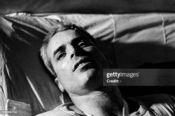 This file picture taken in 1967 shows US Navy Airforce Major John McCain lying on a bed in a Hanoi hospital as he was being given medical care for...