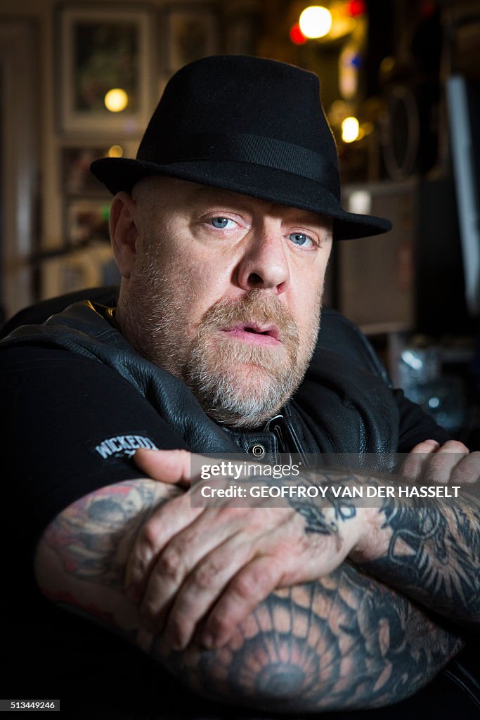 French tattoo artist TinTin poses in his tattoo parlor in Paris on