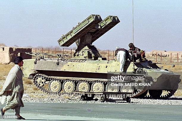 Taliban Islamic militia commandos prepares with their multi-barrel rocket launcher near the India hijacked plane parked at Kandahar airport in...