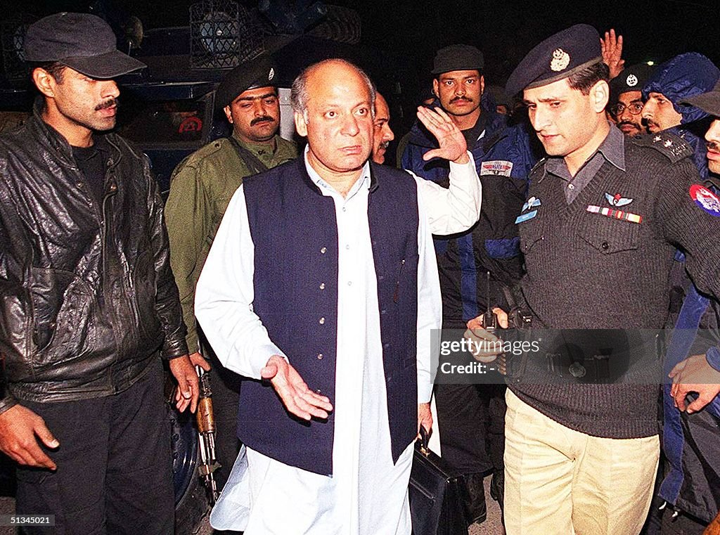 Security officials escort deposed Prime Minister N
