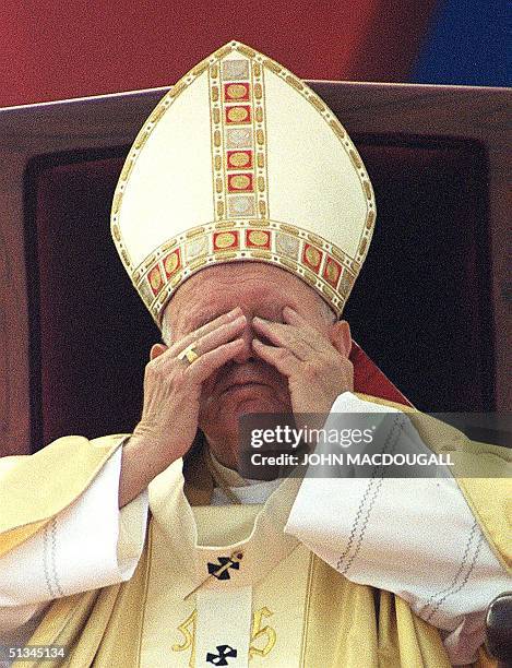 Pope John Paul II rubs his eyes during a mass attended by some 50,000 Indian Catholics in the giant Jawaharlal Nehru Stadium 07 November 1999 in...