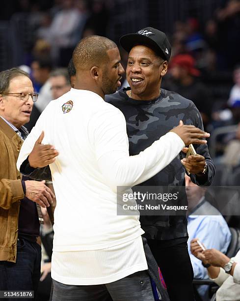 Jay-Z talks to Chris Paul at a basketball game between the Oklahoma City Thunder and the Los Angeles Clippers at Staples Center on March 2, 2016 in...