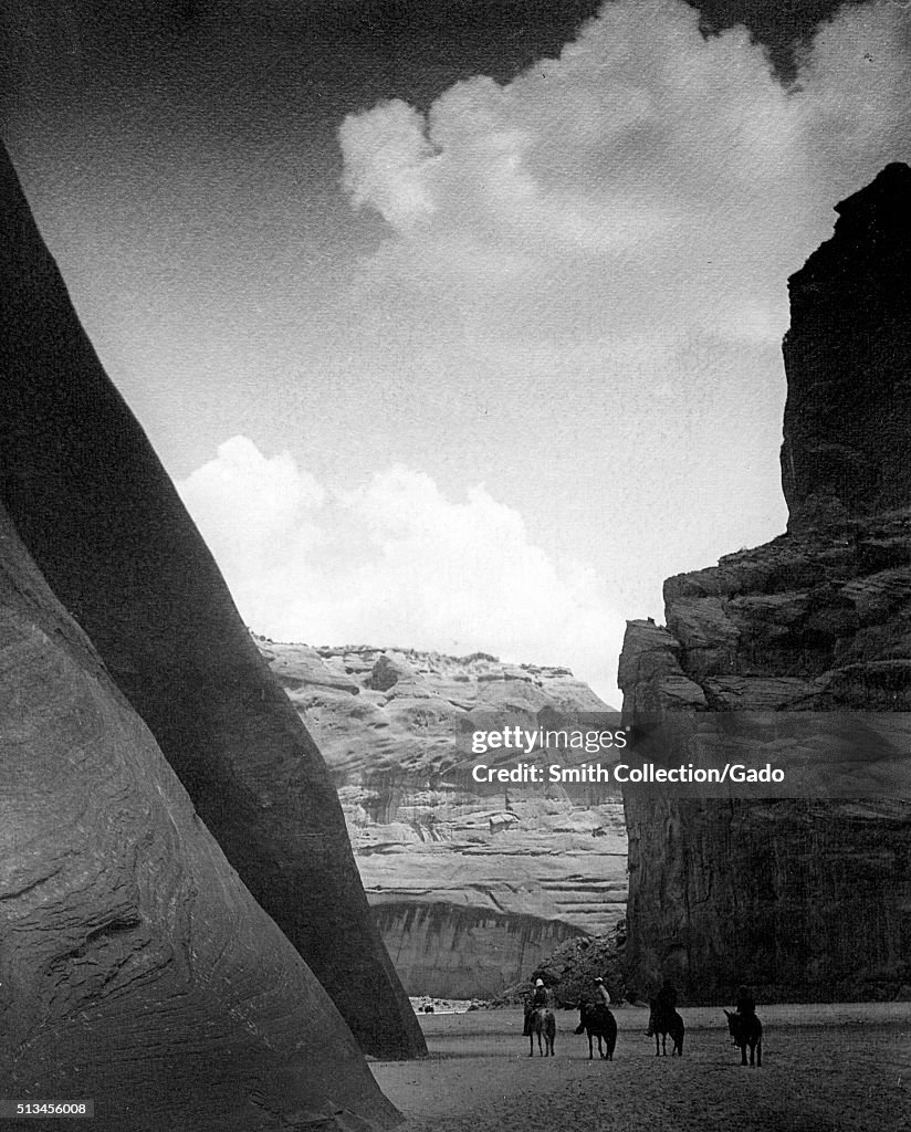 Four Navajo People In A Canyon