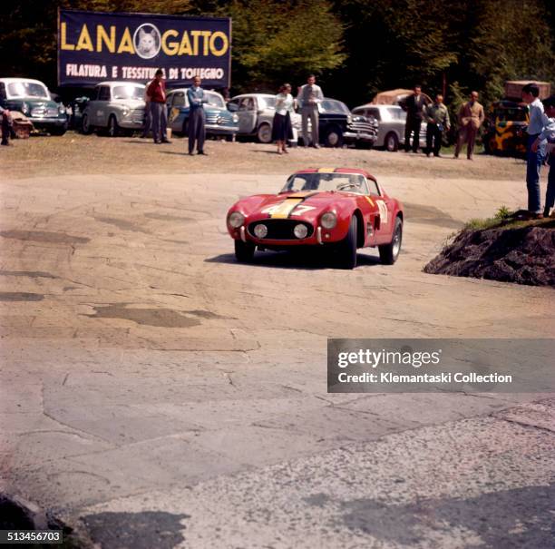 Belgian racing driver, Olivier Gendebien , rounds a tight corner on the way up the Futa Pass in his Ferrari 250 GT Berlinetta "Tour de France" during...