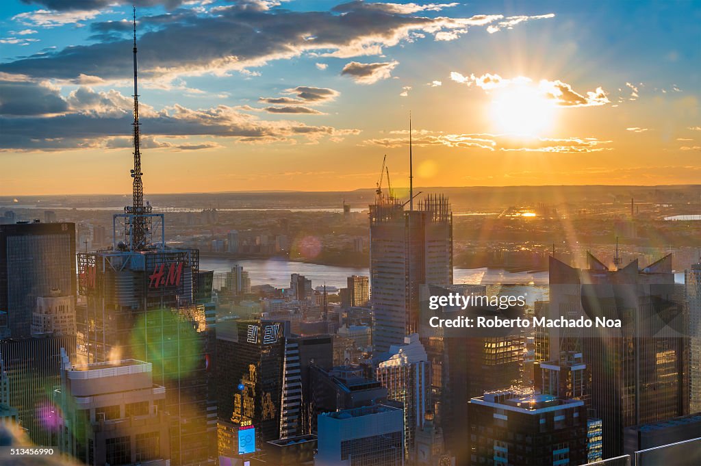 Sunset over New York city skyline: brilliant yellow and...