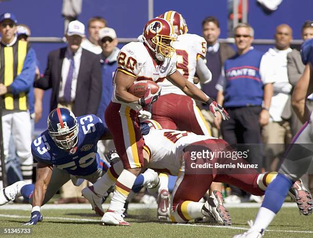 Wesly Mallard of the New York Giants tries to tackle Chad Morton of the Washington Redskins during a kickoff return in the game on September 19, 2004...