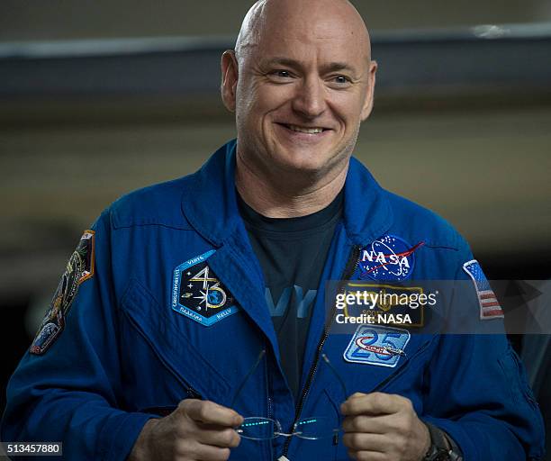 In this handout provided by NASA, Scott Kelly of NASA is seen as he arrives after landing at Ellington Field after his return to Earth on March 3,...