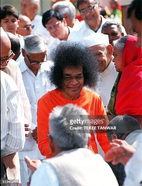 Indian religious guru Sathya Sai Baba greets followers after the inauguration the Sai International Centre, which intends to promote the appreciation...