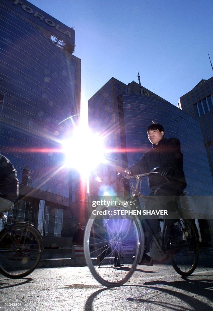 A man rides his bicycle past Motorola's and Hewlit