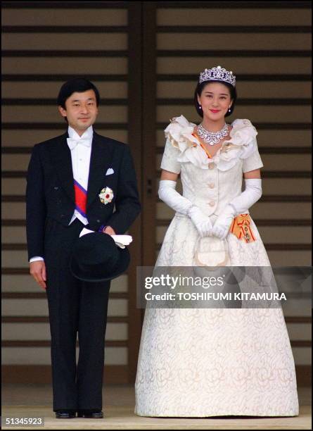 The newly wed Crown Prince Naruhito and his wife, Crown Princess Masako pose for photographs 09 June 1993 after their wedding ceremony at the Tokyo...