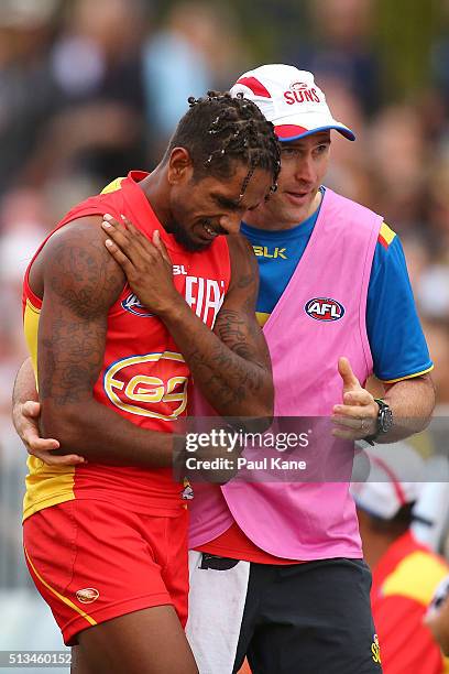 Jarrod Garlett of the Suns comes from the field with a shoulder injury during the 2016 AFL NAB Challenge match between the West Coast Eagles and the...