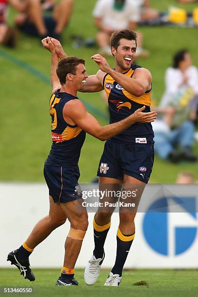 Jamie Cripps and Fraser McInnes of the Eagles celebrate a goal during the 2016 AFL NAB Challenge match between the West Coast Eagles and the Gold...