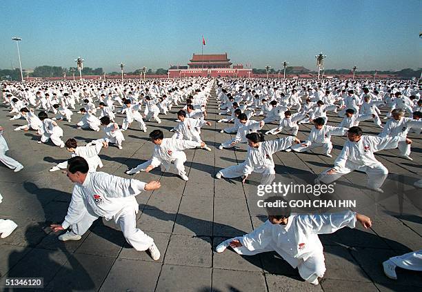Some ten thousand martial artists move in perfect unison in Beijing's Tiananmen Square 15 October, displaying the art of Tai Chi or Chinese...