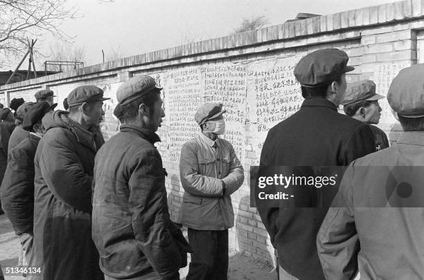 In this picture dated 05 December 1978 during the early days of the democracy movement in China, people read posters hanging on the famous "Democracy...