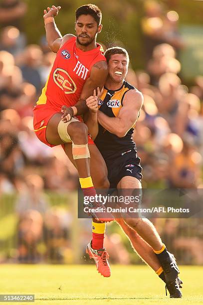 Patrick McGinnity of the Eagles bumps Aaron Hall of the Suns during the 2016 NAB Challenge match between the West Coast Eagles and the Gold Coast...