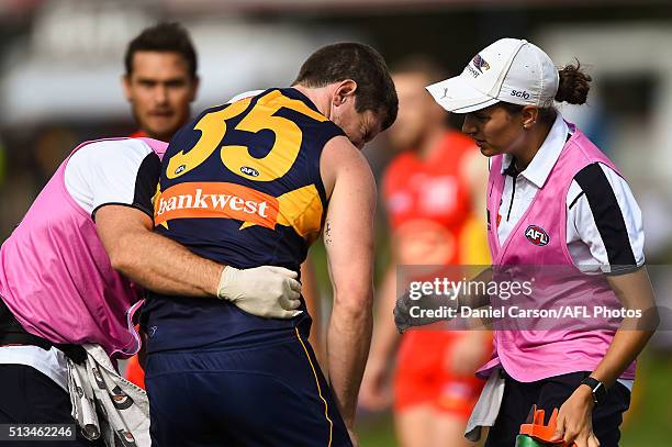 Patrick McGinnity of the Eagles is assisted off the field with an injury during the 2016 NAB Challenge match between the West Coast Eagles and the...