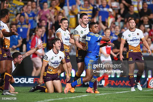 Sam Thaiday, Darius Boyd, Ben Hunt, James Roberts and Matt Gillett of the Broncos look to the referee as Michael Jennings of the Eels celebrates...