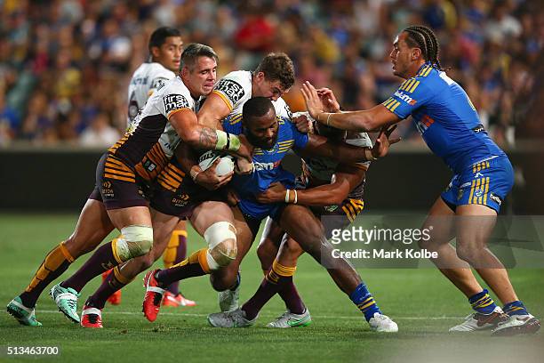 Corey Parker, Corey Oates and Alex Glenn of the Broncos tackle Semi Radradra of the Eels as Brad Takairangi of the Eels watches on during the round...