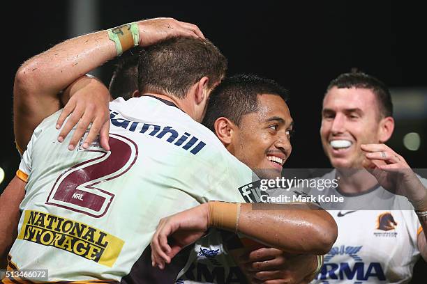 Corey Oates, Anthony Milford and Darius Boyd of the Broncos celebrate a try only to have it disallowed during the round one NRL match between the...