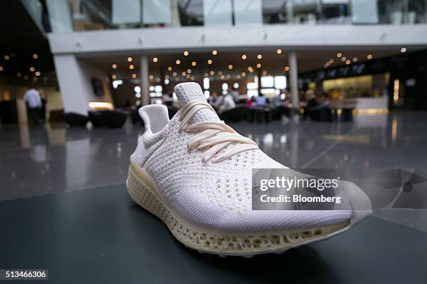 An Adidas prototype sneaker with a 3D printed sole sits on display ahead of a news conference to announce Adidas AG's earnings in Herzogenaurach,...