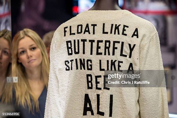 Sarah Foster looks at a signed 'Float like a butterfly sting like a bee' robe worn by Ali's cornerman Bundini Brown at the 'Rumble in the Jungle'...