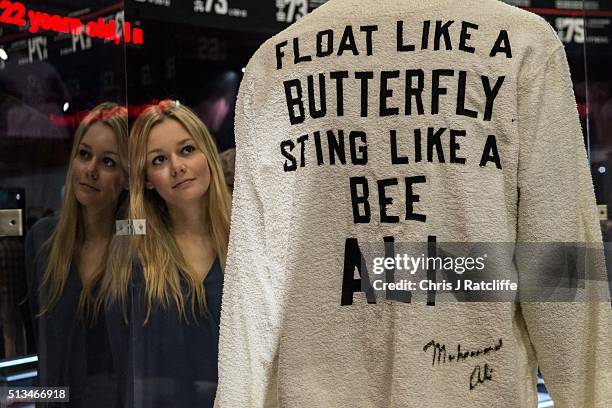 Sarah Foster looks at a signed 'Float like a butterfly sting like a bee' robe worn by Ali's cornerman Bundini Brown at the 'Rumble in the Jungle'...