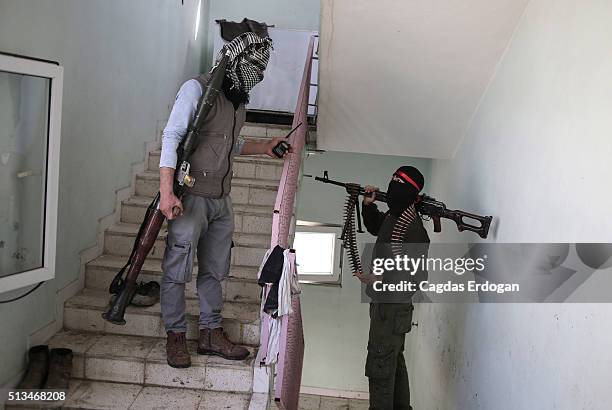 Members of armed group Patriotic Revolutionary Youth Movement , a youth division of the Kurdistan Workers' Party, PKK, talk on the stairs in a house...