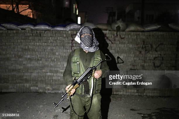 Member of a armed group Patriotic Revolutionary Youth Movement , a youth division of the Kurdistan Workers' Party, PKK, pose with his AK-47 in the...