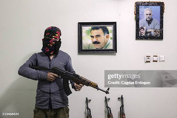Member of a armed group Patriotic Revolutionary Youth Movement , a youth division of the Kurdistan Workers' Party, PKK, pose with his AK-47 next to a...