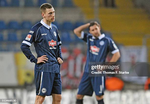 Manuel Junglas and Stephan Salger of Bielefeld look dejected after losing the Second Bundesliga match between Arminia Bielefeld and SC Freiburg at...