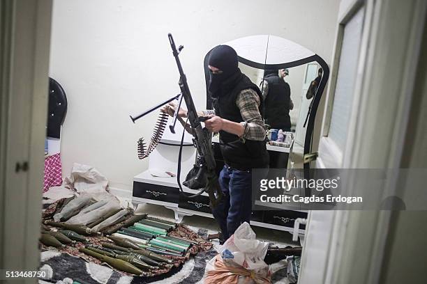 Member of armed group Patriotic Revolutionary Youth Movement , a youth division of the Kurdistan Workers' Party, PKK, prepare his weapons in a house...