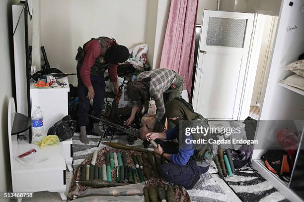 Members of armed group Patriotic Revolutionary Youth Movement , a youth division of the Kurdistan Workers' Party, PKK, prepare their weapons in a...