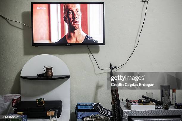 An AK-47 is seen under a television in a living room of the members of armed group Patriotic Revolutionary Youth Movement , a youth division of the...