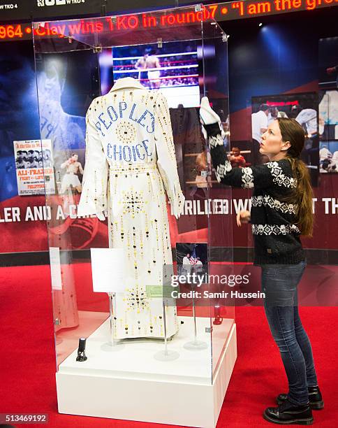 Glass case with a replica of Muhammad Ali's 'Peoples Choice' robe is cleaned during a photocall to preview the Muhammad Ali exhibition entitled 'I Am...