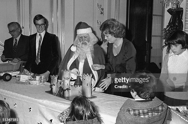 From left: Prince Rainier III, Prince Albert, Christmas Father, Princess Grace and Princess Stephanie offer gifts to some Monte-Carlo children during...