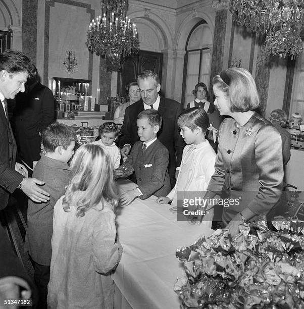 From left: Princess Stephanie, Prince Rainier III, Prince Albert, Princess Caroline and Princess Grace, offer gifts to some Monte-Carlo children...