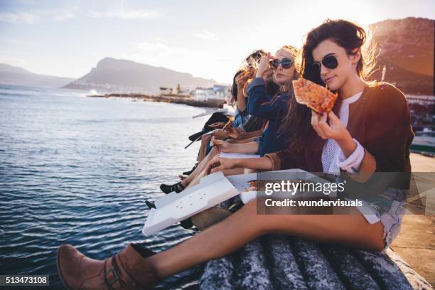 hipster style teenager friends eating pizza on the dock - american pizza stock pictures, royalty-free photos & images