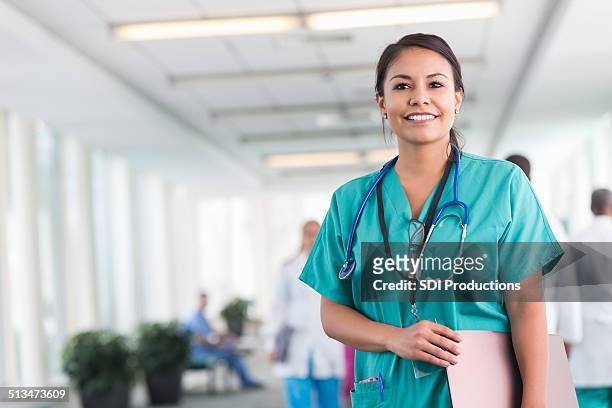 confident hospital nurse smiling while working in modern hospital - spoedeisende hulp stockfoto's en -beelden