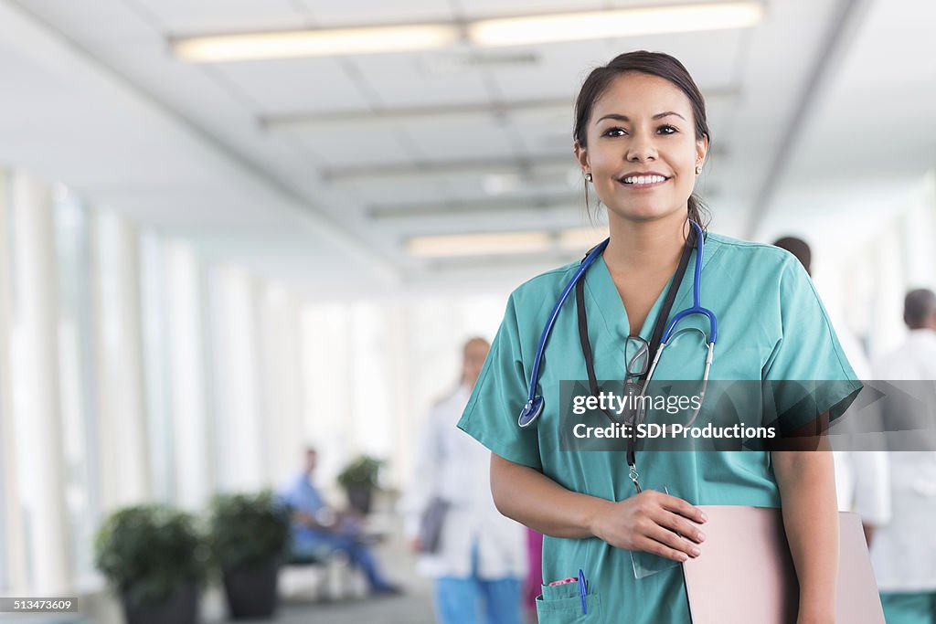 Confident hospital nurse smiling while working in modern hospital
