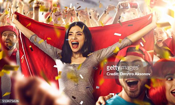 sport fans: a girl holds a flag in her hands - fan stockfoto's en -beelden