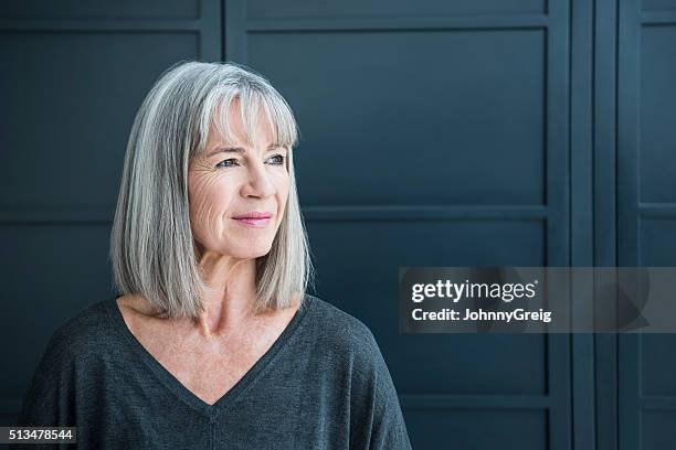 senior woman with gray hair looking away - pony haardracht stockfoto's en -beelden