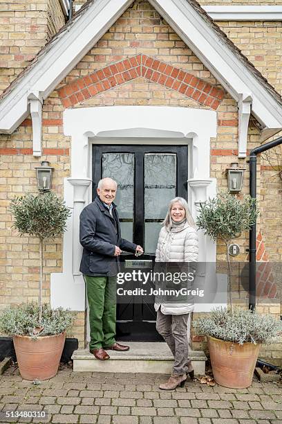 senior couple standing by porch of house - in front of stock pictures, royalty-free photos & images