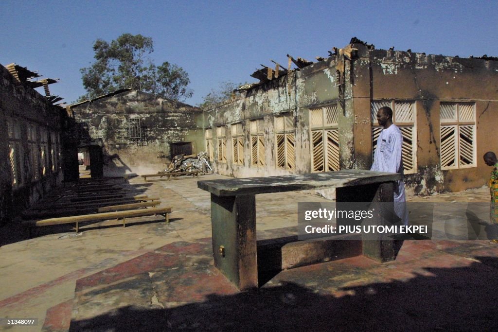 A worshipper walks 30 November 2002 among the debr