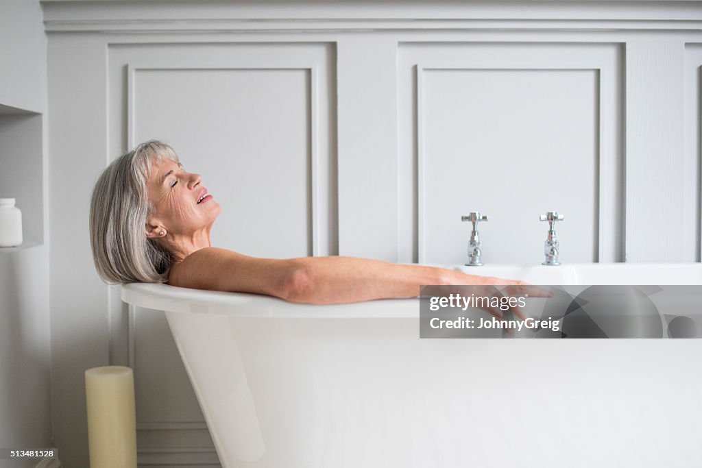Senior woman relaxing in bath with eyes closed