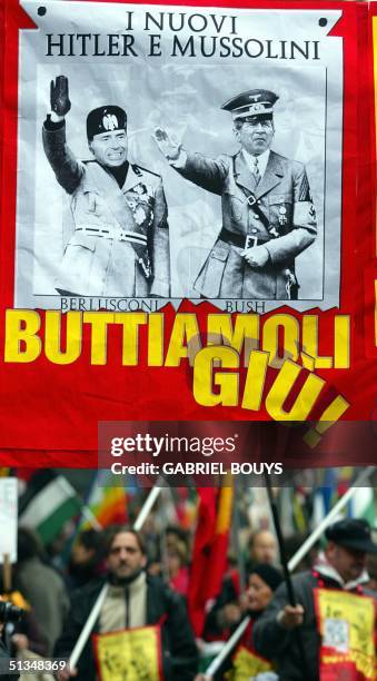 Demonstrators hold a poster depicting US President George W Bush as Hitler and Italian Prime Minister Silvio Berlusconi as Mussolini participate at a...